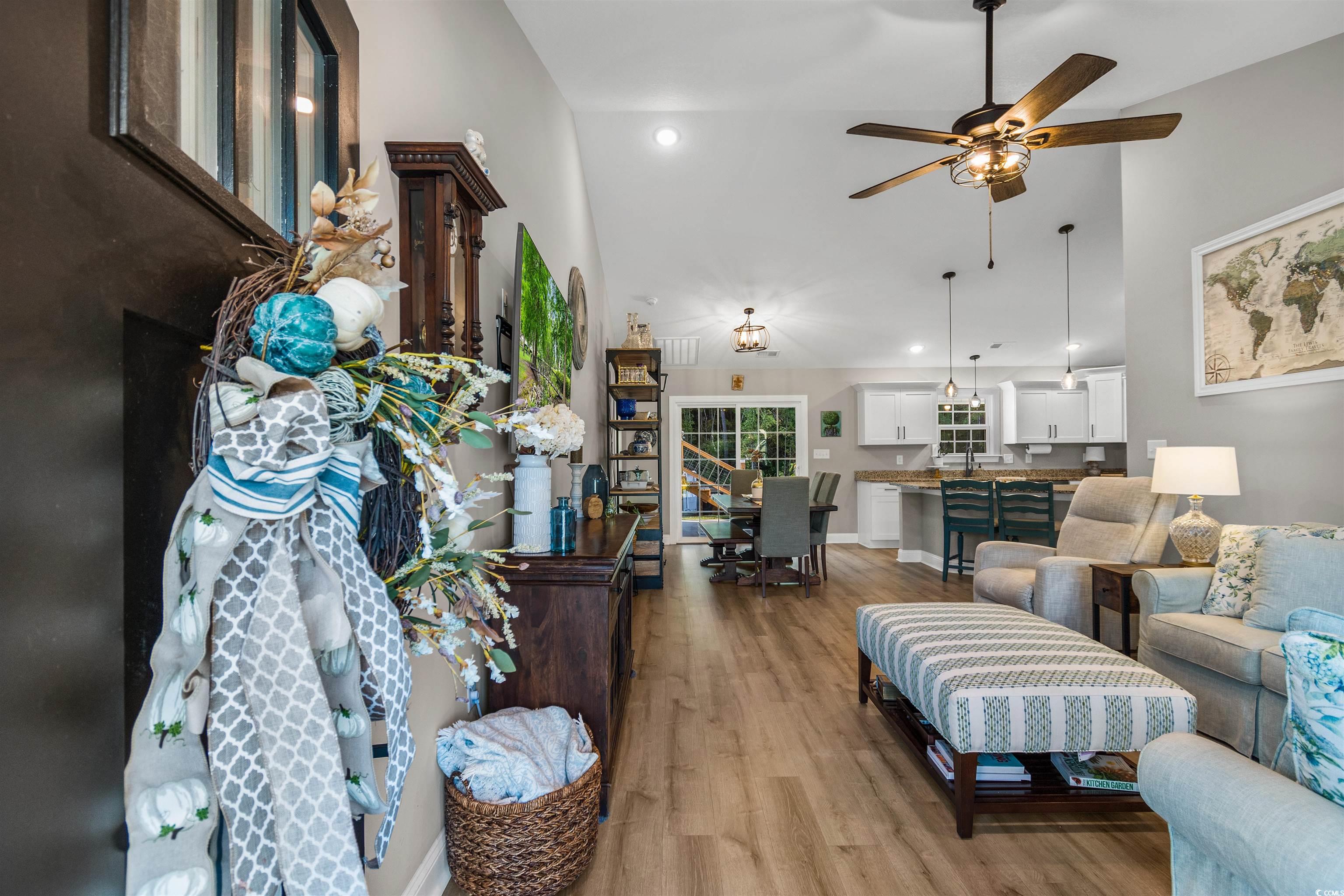 Living room featuring lofted ceiling, light hardwo