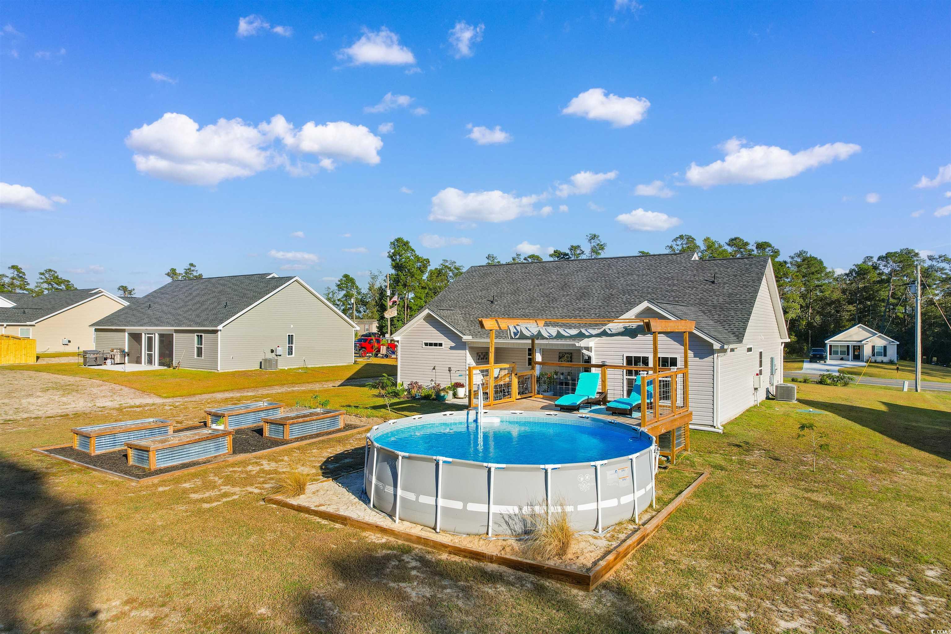 2279 Vaught Road Galivants Ferry, SC 29544 - Photo 34 of 40 View of swimming pool with a patio area and a lawn