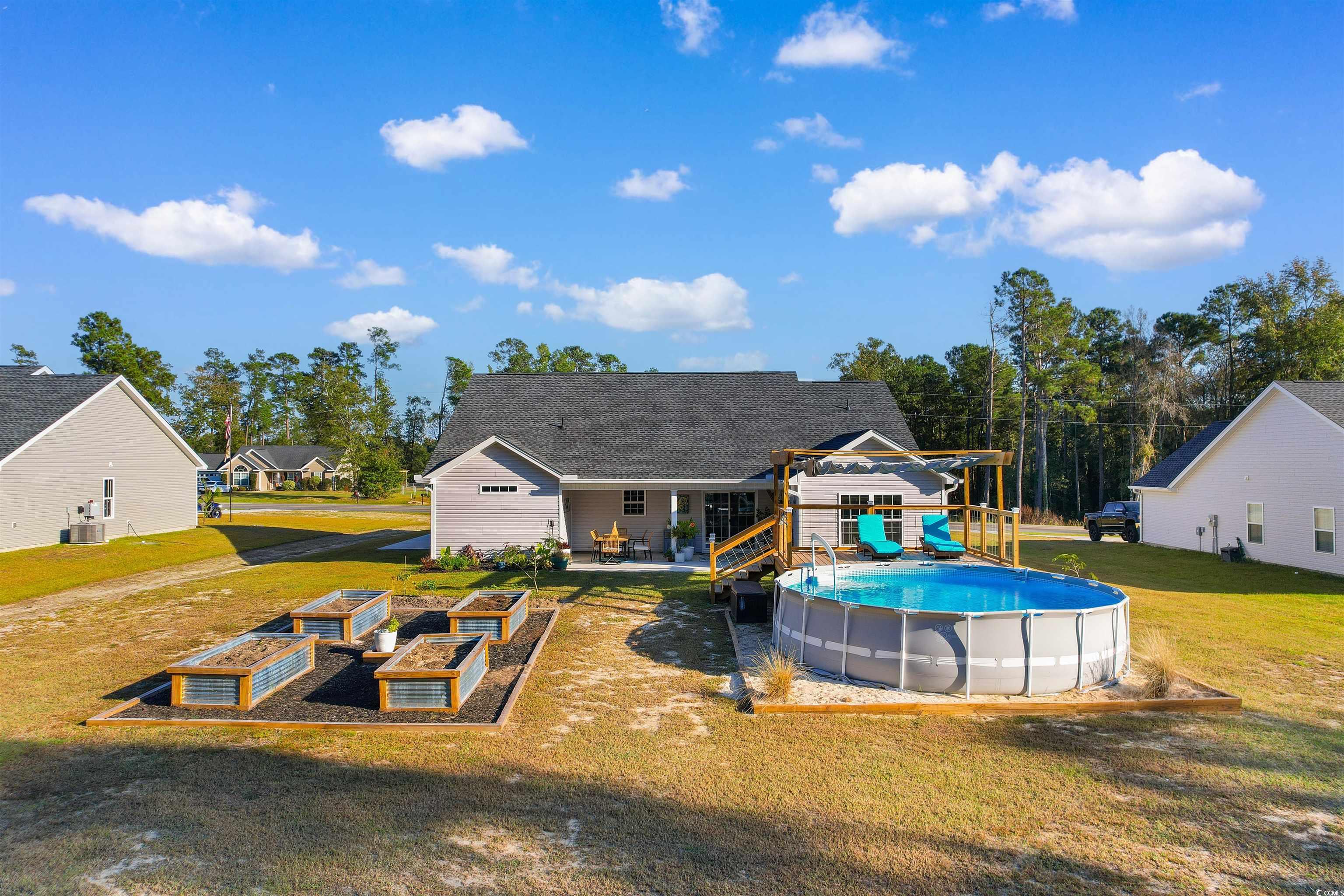 2279 Vaught Road Galivants Ferry, SC 29544 - Photo 37 of 40 View of pool with a wooden deck and a yard
