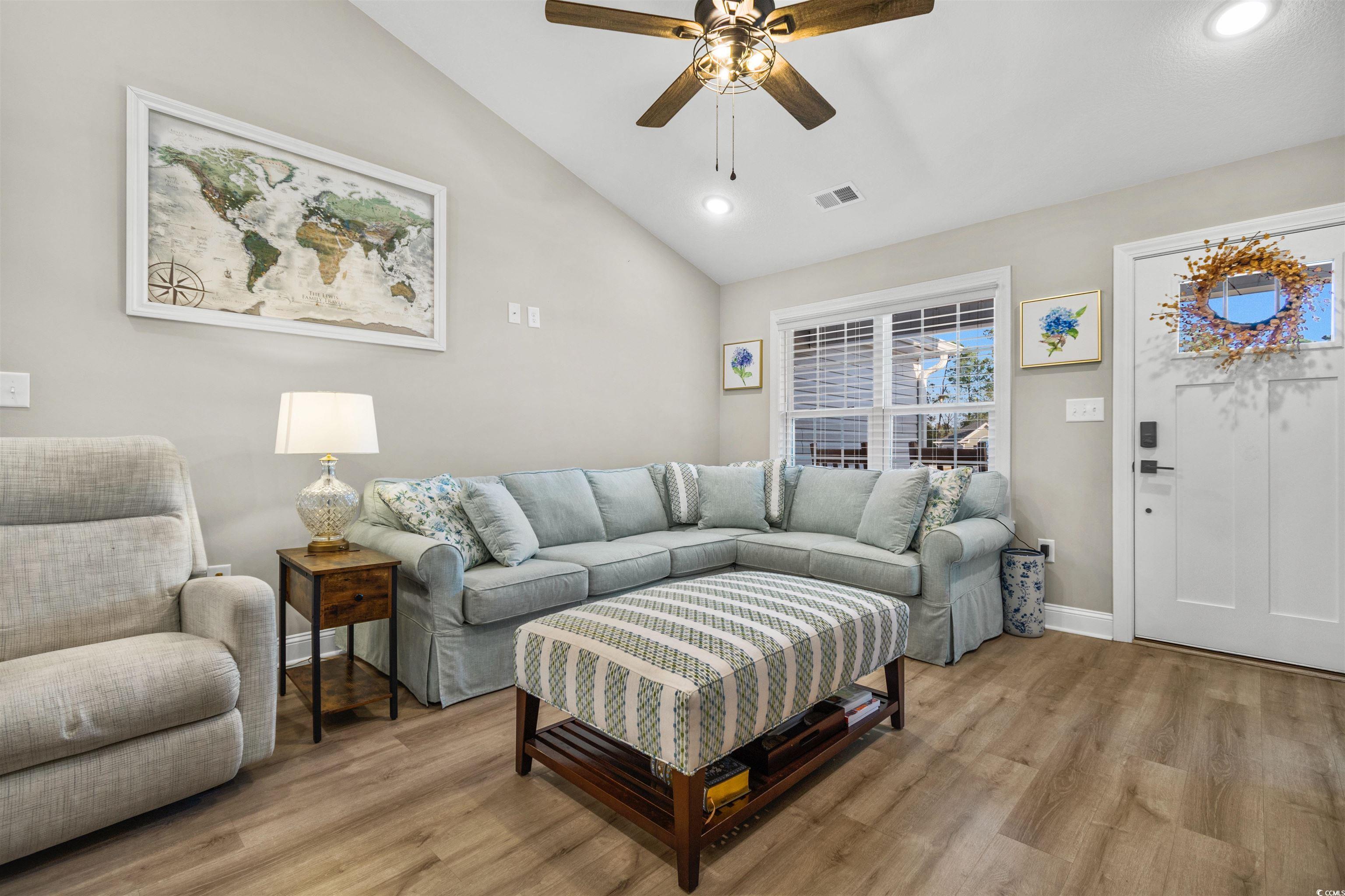 Living room with light hardwood / wood-style floor
