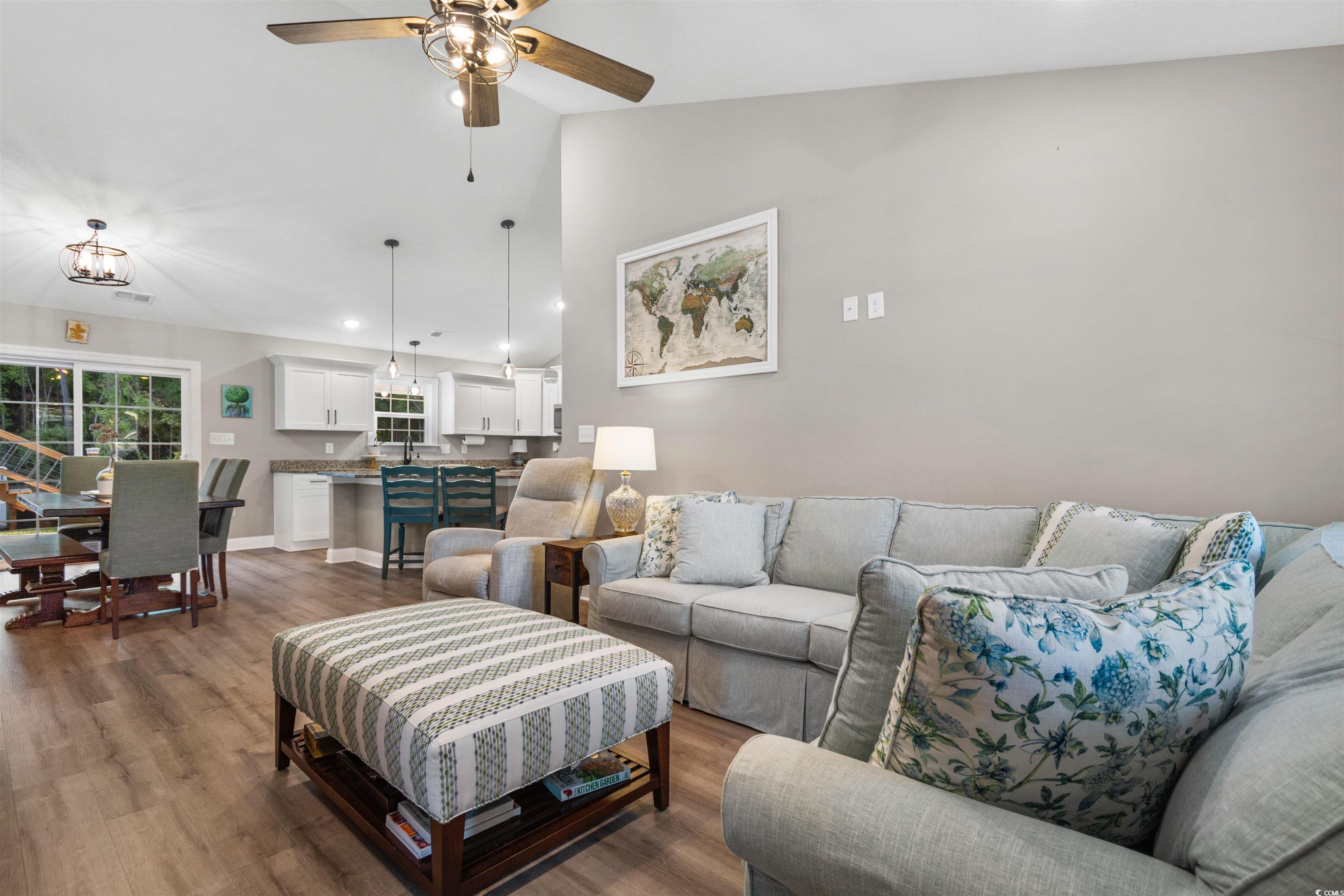 Living room featuring lofted ceiling, dark wood-ty