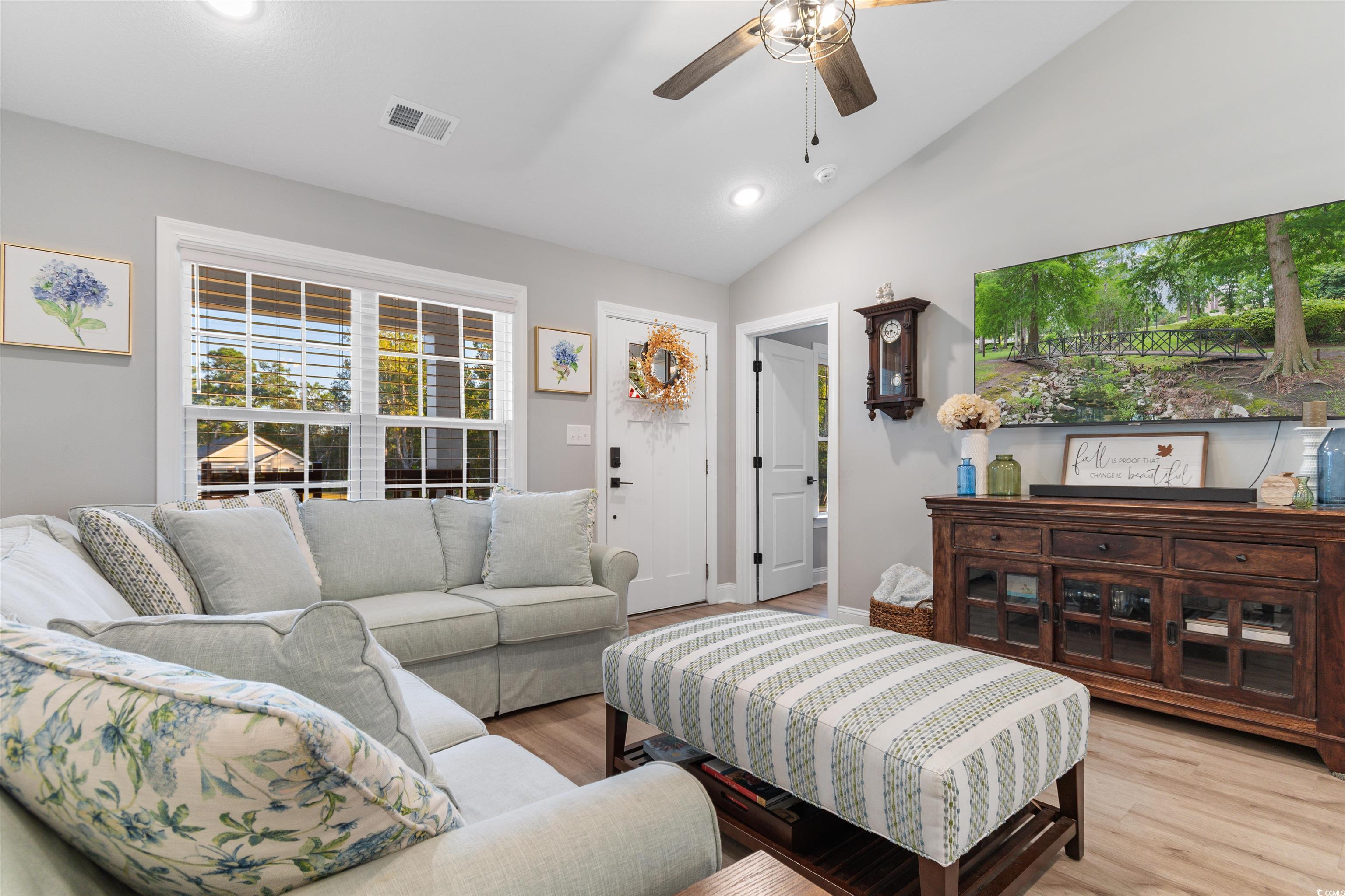 Living room with light hardwood / wood-style floor