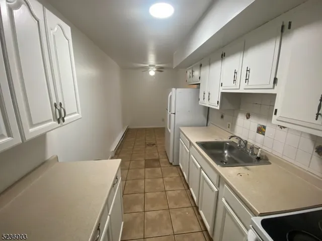 a kitchen with a sink a stove and cabinets
