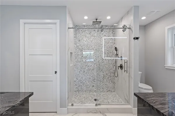 a kitchen with kitchen island a sink stainless steel appliances and cabinets