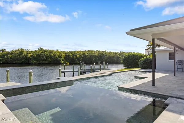 a bathroom with a granite countertop bathtub sink vanity and mirror