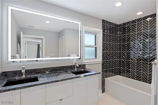 a kitchen with stainless steel appliances a refrigerator and a stove top oven