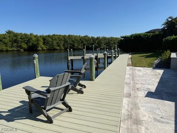 a view of a lake with couches chairs