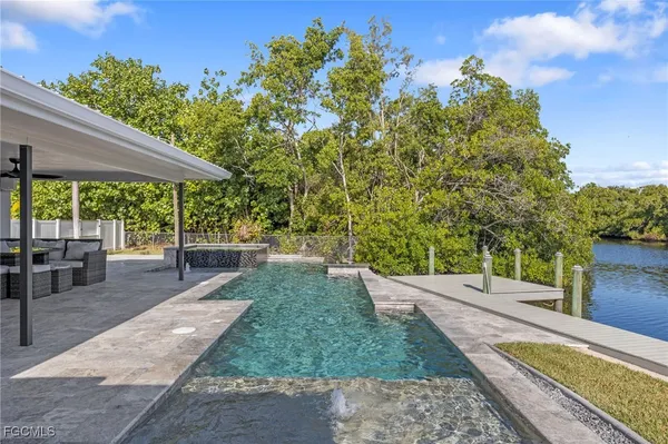 a living room with lots of furniture and a large window