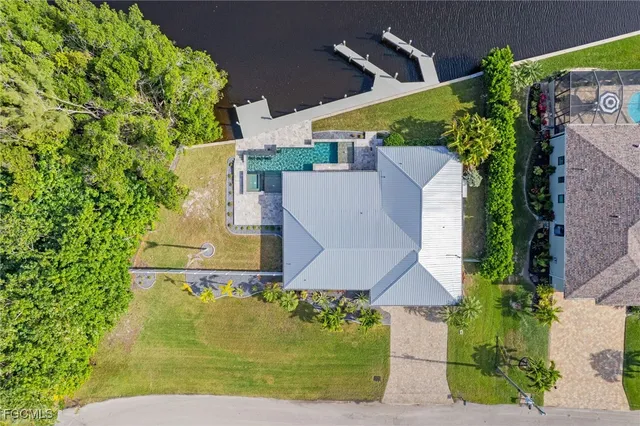 an aerial view of a house with garden space and street view