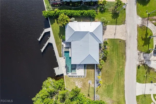 an aerial view of a house with a garden and lake view