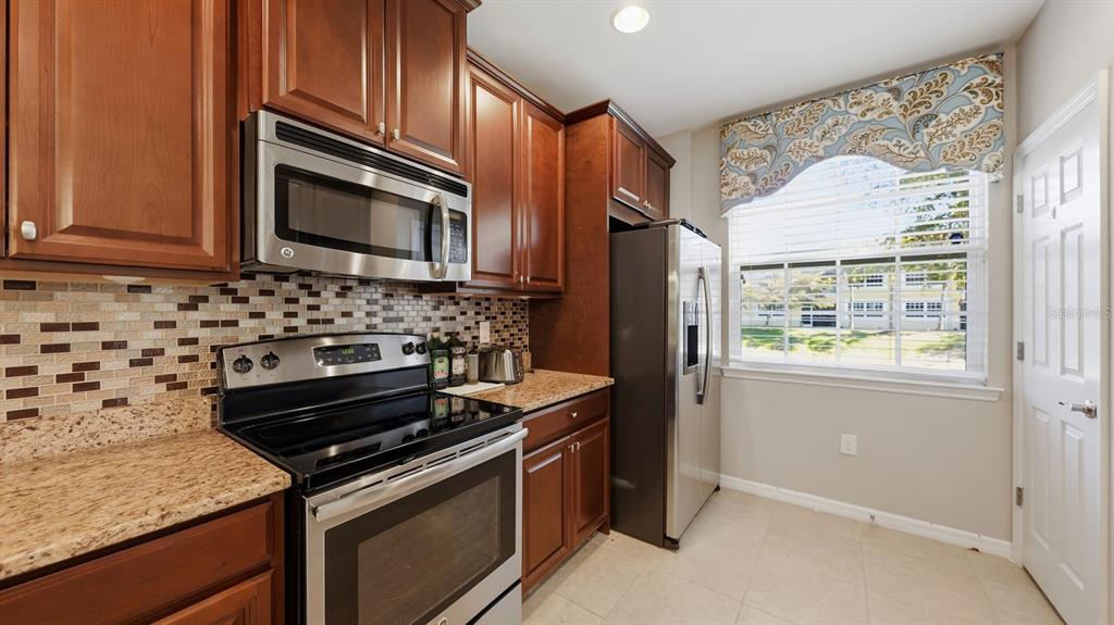 177 Navigation Circle Osprey, FL 34229 - Photo 17 of 43 a kitchen with stainless steel appliances granite countertop a stove microwave and refrigerator