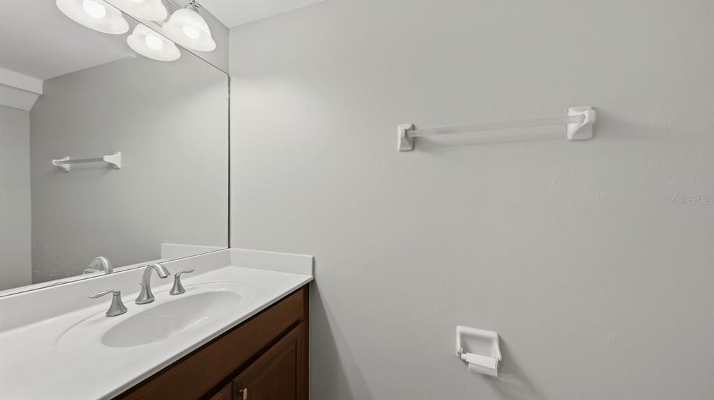 177 Navigation Circle Osprey, FL 34229 - Photo 19 of 43 a bathroom with a sink vanity and a mirror