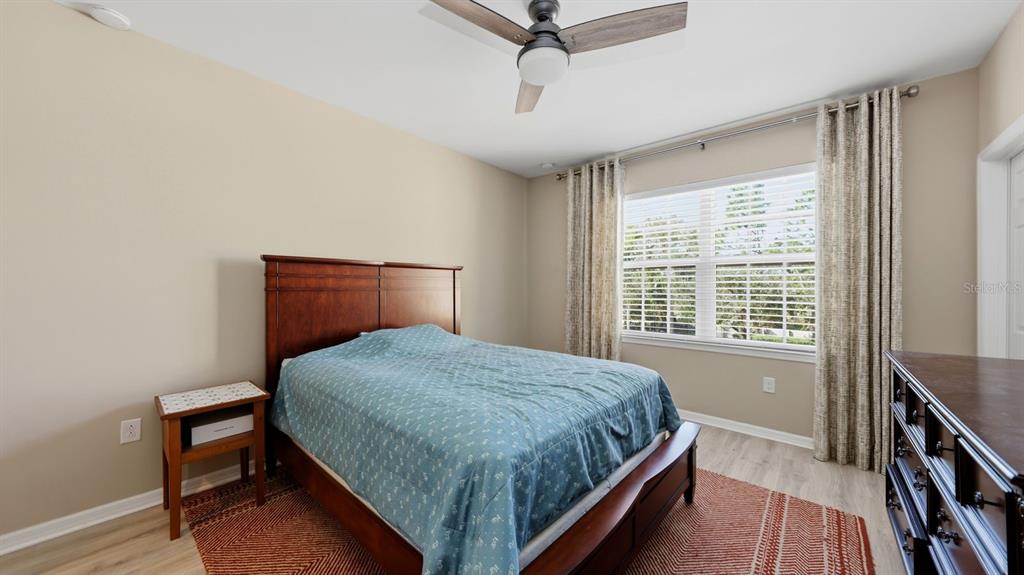 177 Navigation Circle Osprey, FL 34229 - Photo 22 of 43 a bedroom with a bed and a dresser next to a window