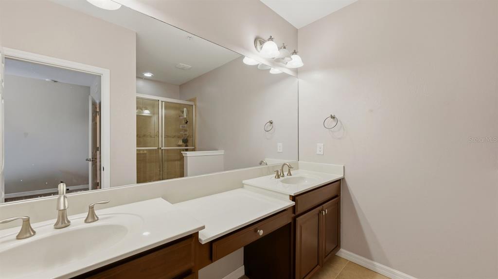 177 Navigation Circle Osprey, FL 34229 - Photo 25 of 43 a bathroom with a sink a light fixture and a mirror