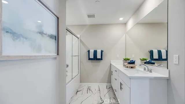 a bathroom with a double vanity sink mirror and shower