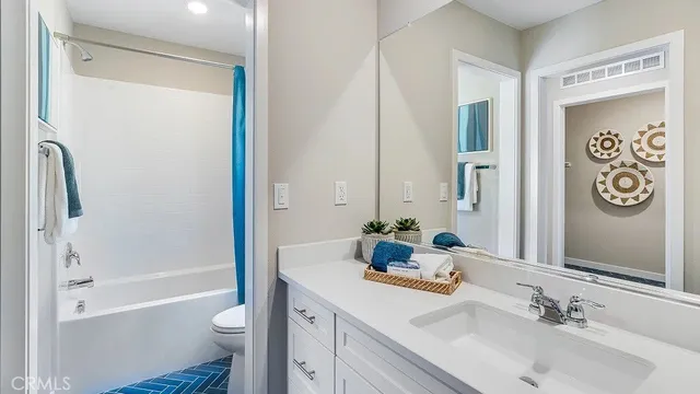 a bathroom with a tub sink toilet and a mirror