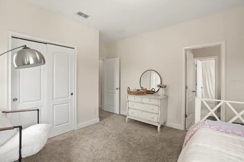 a bedroom with a bed and a dresser