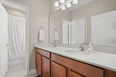 a bathroom with a double vanity sink and a mirror