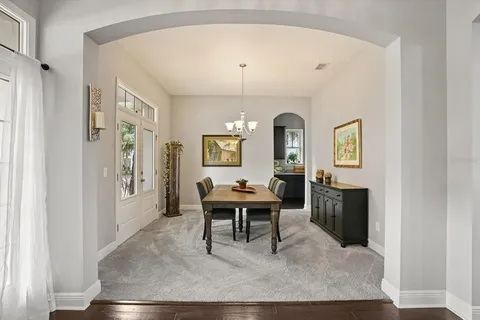 a living room with furniture a table and a painting on the wall