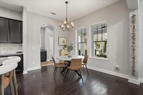a view of a dining room with furniture window and wooden floor