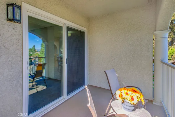 a kitchen with stainless steel appliances granite countertop a refrigerator a sink dishwasher a stove with wooden cabinets and floor