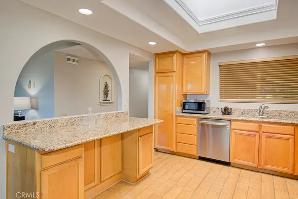 a kitchen with a refrigerator sink and cabinets