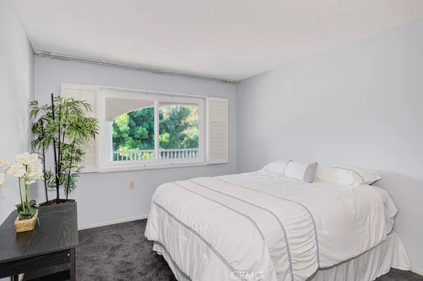 a bedroom with a bed and a shower
