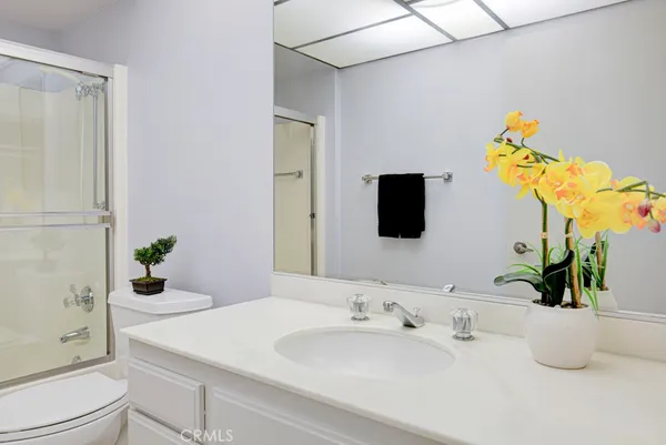 a bedroom with a bed potted plant and a window