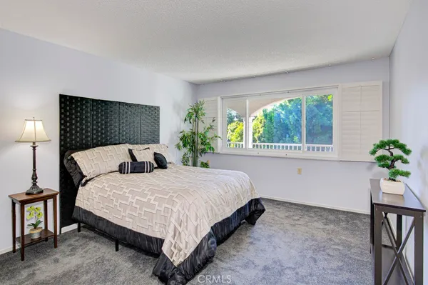 a bedroom with a bed and window