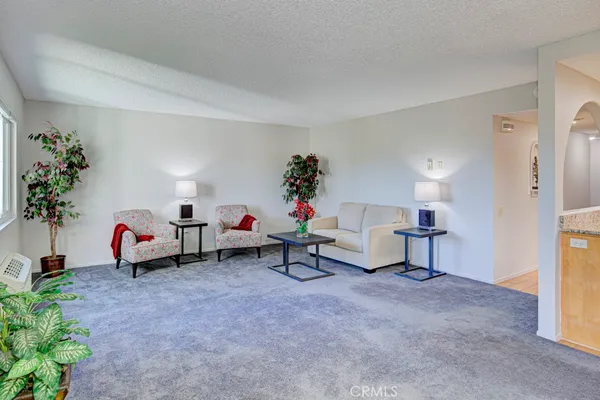 a living room with furniture and a kitchen