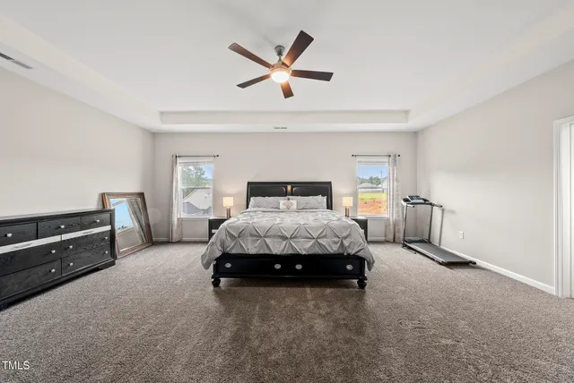 a bedroom with a bed and ceiling fan