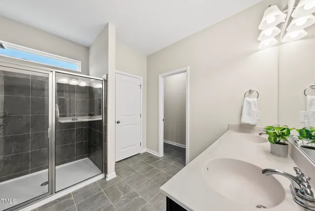 a bathroom with a sink and shower