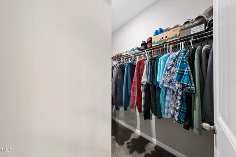 a view of walk in closet with clothes