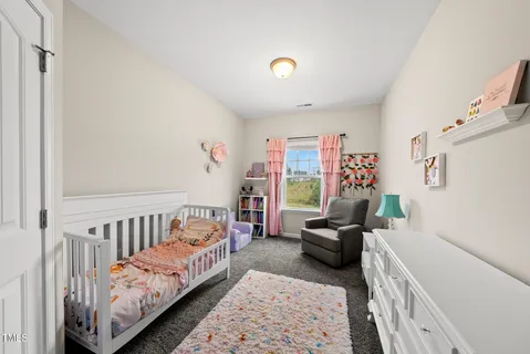 a bedroom with furniture and a window