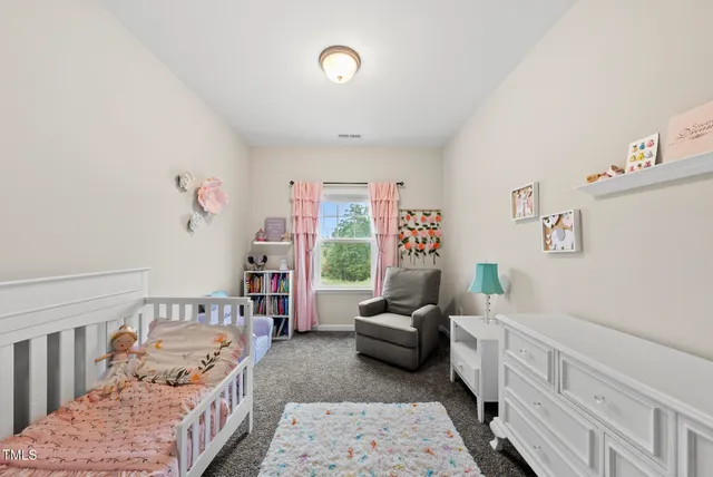 a bedroom with furniture and a large window