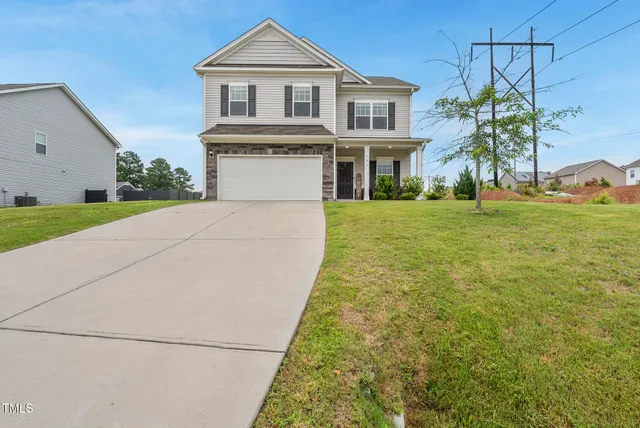a front view of a house with a yard and garage