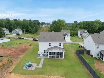 an aerial view of a house with a yard