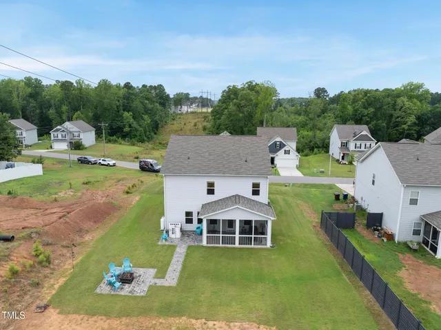 an aerial view of a house with a yard