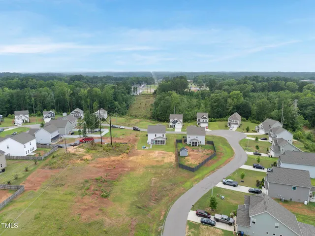 an aerial view of a swimming pool with seating space