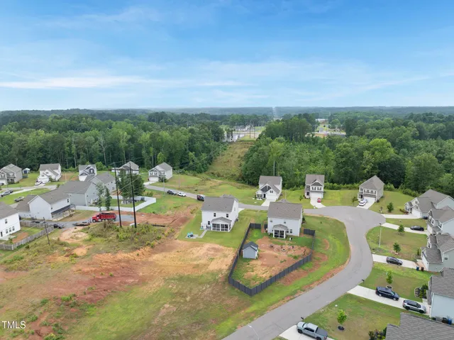 a view of a chairs and table in backyard