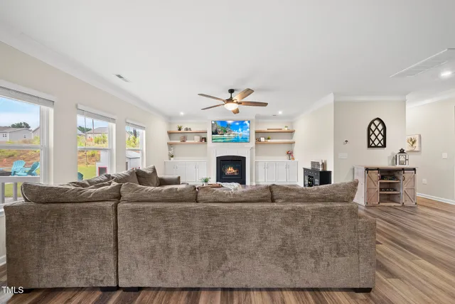 a living room with fireplace furniture and a chandelier