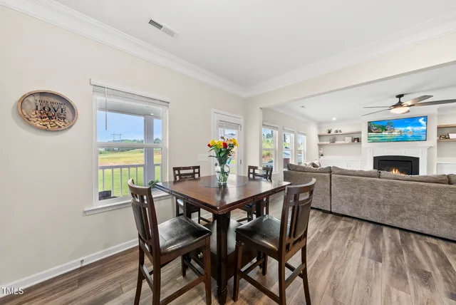 a view of a dining room with furniture and wooden floor
