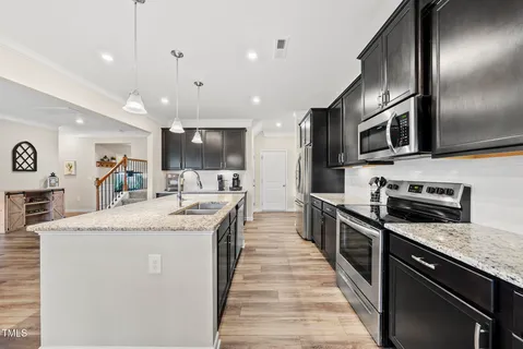 a large kitchen with stainless steel appliances and a sink