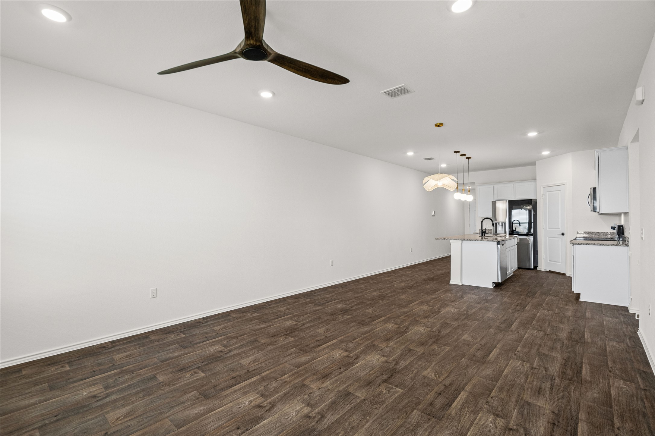 15004 Welsh Cobb Rd Manor, Unit A Manor, TX 78653 - Photo 12 of 22 Open-concept living area featuring wood-finish flooring, recessed lighting, and a contemporary ceiling fan