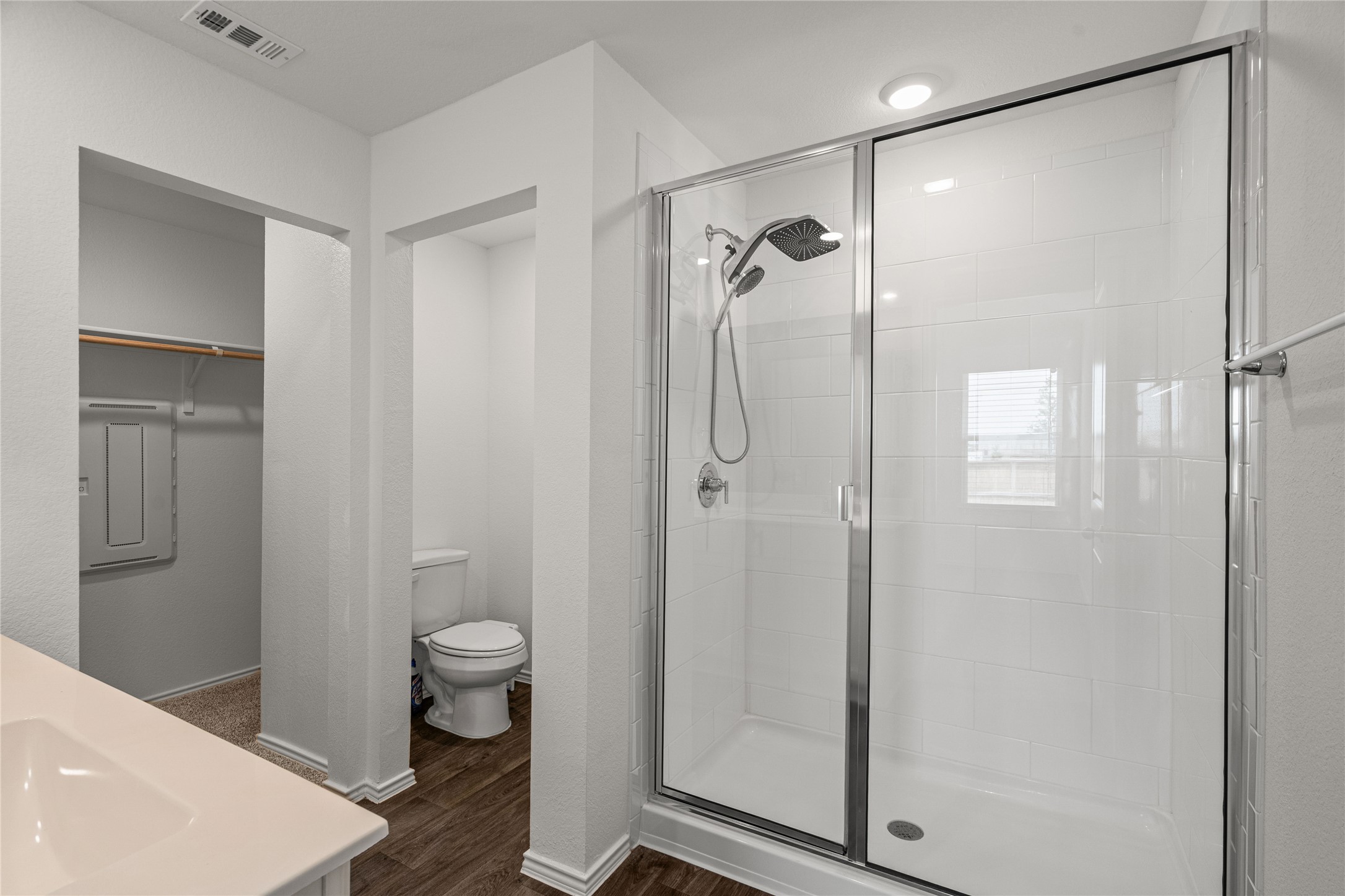 15004 Welsh Cobb Rd Manor, Unit A Manor, TX 78653 - Photo 15 of 22 Spacious bathroom featuring a glass-enclosed shower with subway tile surround, chrome fixtures, and a dual showerhead