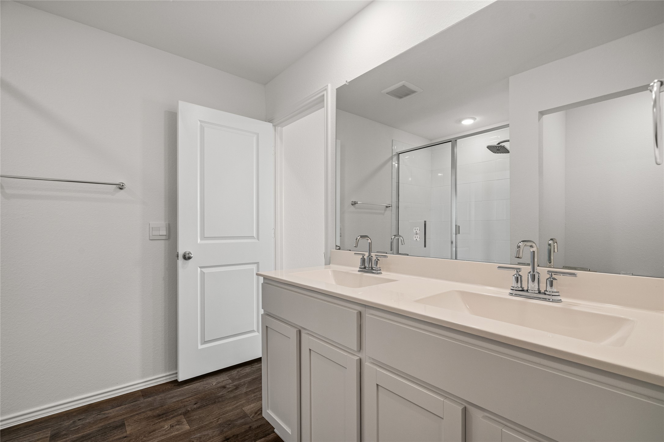 15004 Welsh Cobb Rd Manor, Unit A Manor, TX 78653 - Photo 16 of 22 Dual vanity with integrated sinks and chrome fixtures, complemented by a large wall-mounted mirror