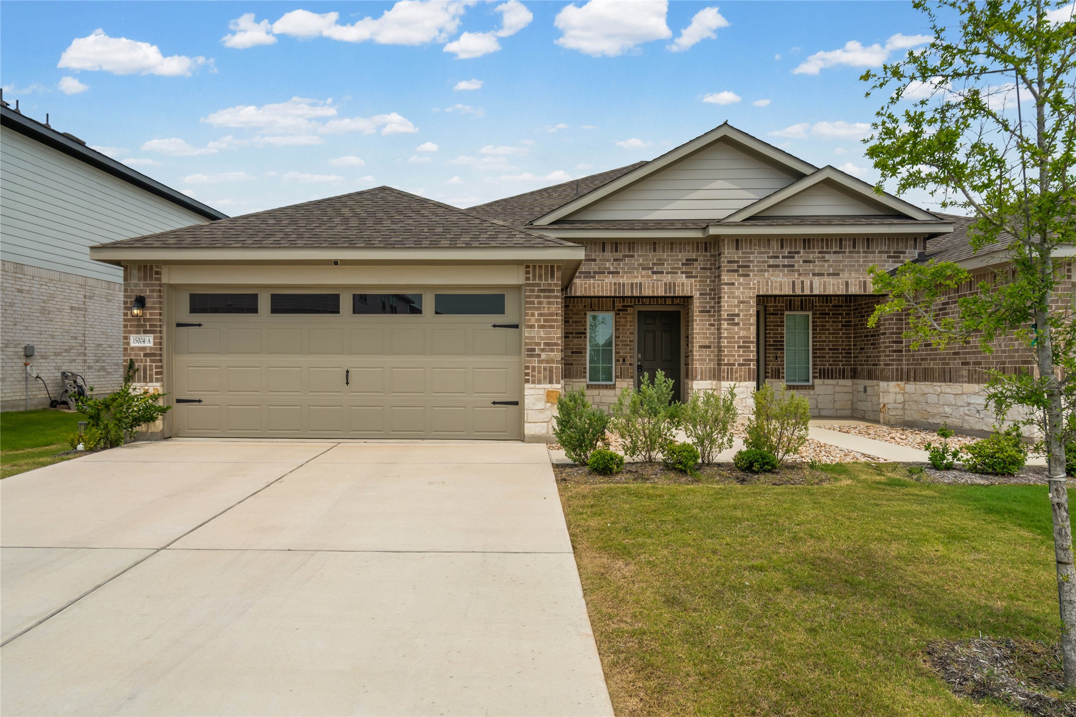15004 Welsh Cobb Rd Manor, Unit A Manor, TX 78653 - Photo 2 of 22 Single-story residence featuring a brick and stone facade