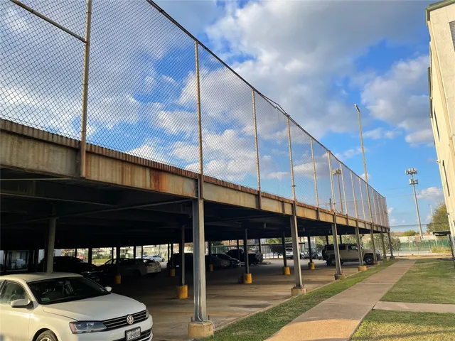 a city view with tall buildings and cars parked on street