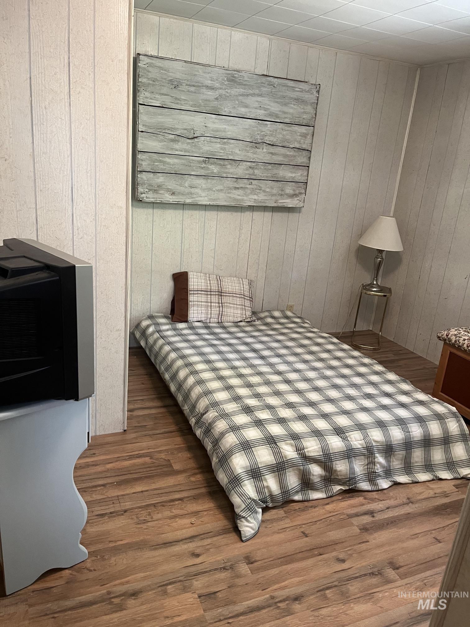 39 Mayflower Mine Road Placerville, ID 83666 - Photo 33 of 36 Wood-finish flooring complements vertical paneling in this room