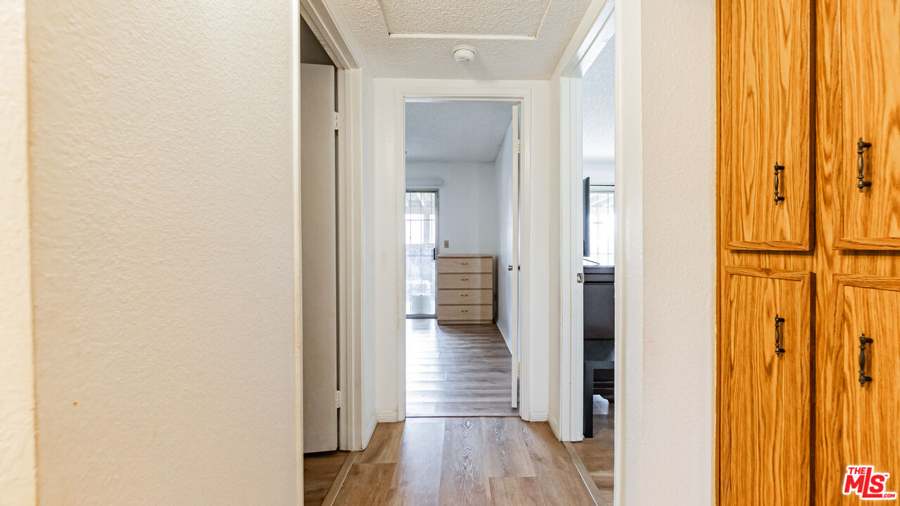 586 San Dimas Street Hemet, CA 92545 - Photo 12 of 30 a view of a hallway with wooden floor